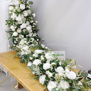 Artificial flower table runner with white roses and green eucalyptus leaves