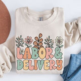 Cream sweatshirt with colorful floral 'LABOR & DELIVERY' front graphic