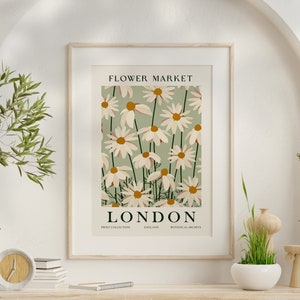 Framed flower market poster with daisies and text “FLOWER MARKET” “LONDON”.