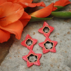 Handmade beaded flower earrings with red petals and black centers