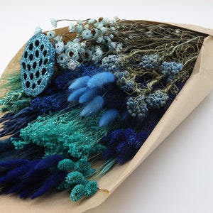 Blue dried flower bouquet bundle in kraft paper wrap, assorted textures and sprigs