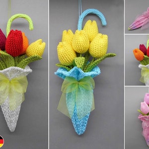 Crocheted tulip flower decoration in umbrella shape, yellow blossoms with green leaves and blue ribbon