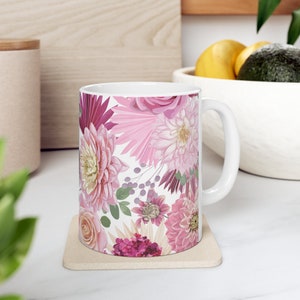 Pink floral ceramic mug with white rim and handle