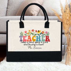Teacher tote bag with floral front print, white canvas and black handles, personalized name.