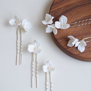 Set of white floral hairpins with small freshwater-pearl accents