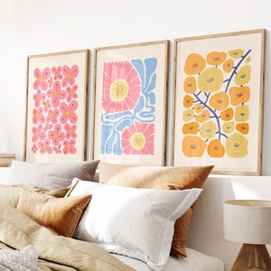 Set of 3 framed floral wall prints with pink, blue, and yellow flower patterns