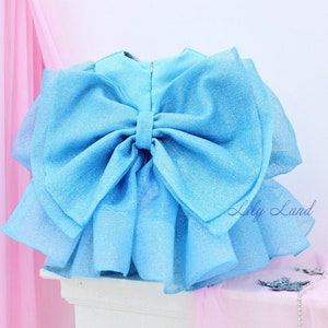 Turquoise sparkling dress with oversized bow and long puffy sleeves