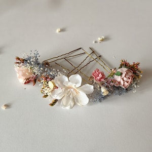 Flower hairpins with blush, cream, and blue flower accents on gold-tone pins