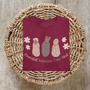 Maroon cotton NICU tee with pastel animal/flower baby-foot graphic and front text