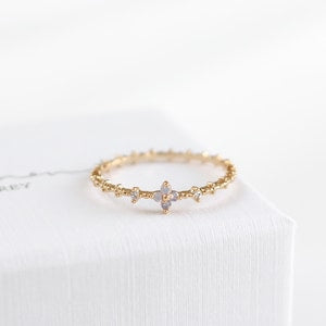 Dainty gold-tone floral ring with pink blossom center