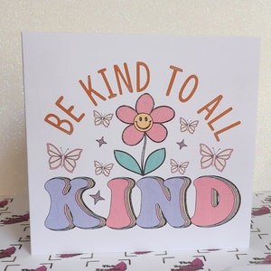 Handmade rainbow glitter affirmation card: “BE KIND TO ALL” with flowers and butterflies