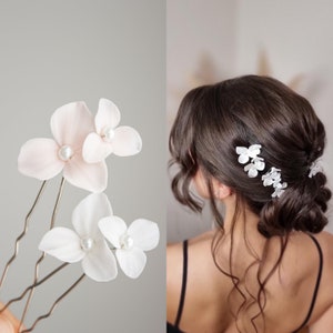 White floral hair pin set with three tiny blossoms and pearl-like centers