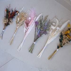 Assorted dried flower bundles with mixed orange, pink, purple, white and yellow blooms