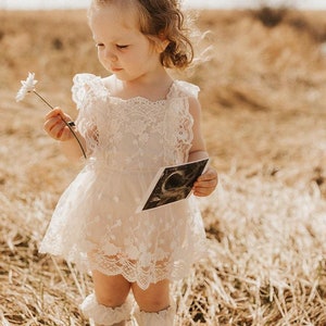 Cream floral lace dress with bow detail and ruffled sleeves