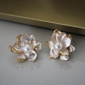 Gold floral pearl stud earrings with white flower petals and round pearl centers