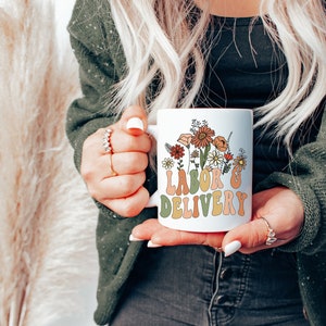 Ceramic coffee mug with floral "Labor Delivery" lettering