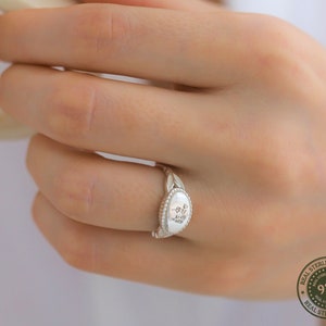 Silver-tone minimalist flower ring with engraved oval center detail for stacking