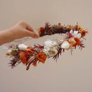 Burnt orange and white dried flower crown with small blossoms and greenery