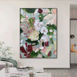 Framed floral wall art with textured white, green, and burgundy abstract flowers