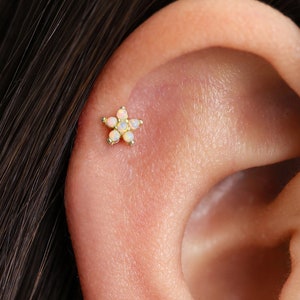 Gold flower cartilage stud earring with small opal-like stones