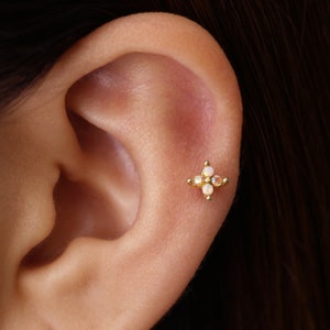 Gold-tone flower cartilage stud earring with iridescent center, flat-back design