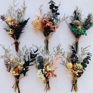Set of mini dried floral bouquets with natural blooms and dark foliage
