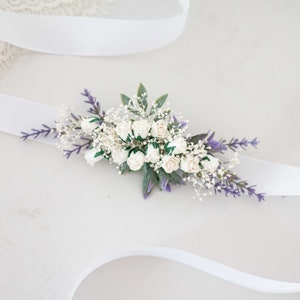 Floral dress belt with white and lavender flowers, green leaves, and jeweled center