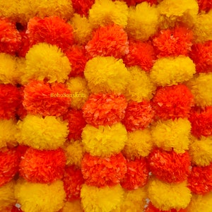 Artificial marigold flower garland with red and yellow pom-poms