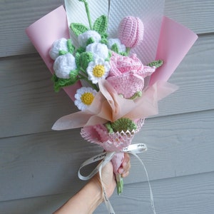 Handmade crochet flower bouquet with pink ribbons, green and pink crocheted blooms