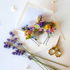 Set of wildflower hairpins with small blue, yellow, and purple blooms on stems
