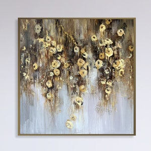 Square abstract floral canvas with gold and beige blooms, framed in wood