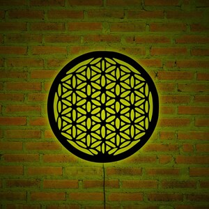 Circular Flower of Life wall art sign with yellow-green LED glow