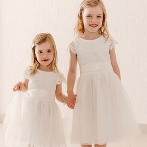 Ivory flower girl dress with lace bodice and tulle skirt, short sleeves