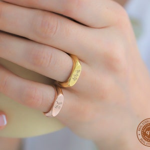 Gold and silver birth flower ring with small engraved floral details on band