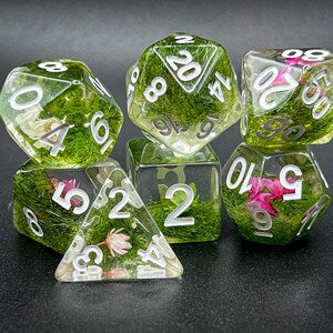 Green translucent RPG dice set with white numbers and flower-filled interiors