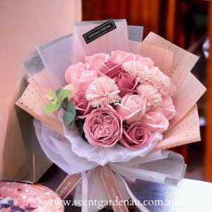 Pastel pink rose soap flower bouquet with curled ribbon wrap and greenery accents