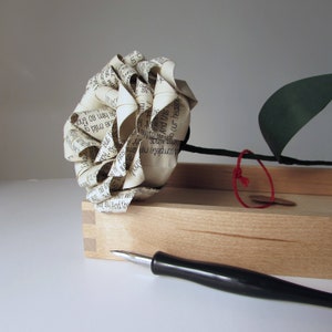 Typewriter-style paper rose made from printed paper, beige and white, spiral bloom