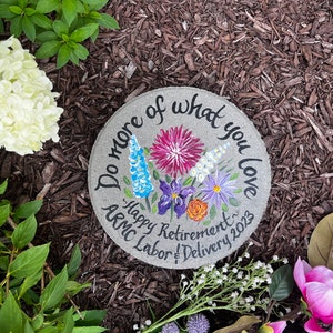 Round garden paver stone with colorful wildflower design and retirement message