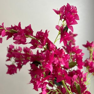 Fuchsia faux bougainvillea flower stem with clustered artificial blossoms on green stems