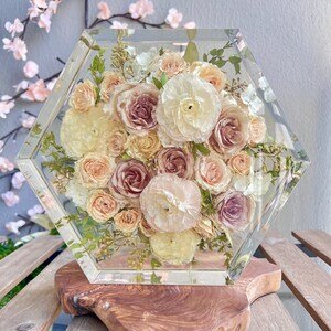 Clear hexagon resin flower block with preserved roses, greenery, on wooden base