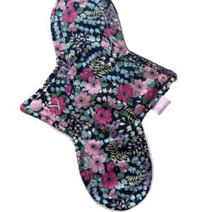 Reusable cloth period pad, navy with pink floral print, contoured shape, snap closure