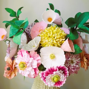 Paper flower bouquet with white and pink blossoms and green leaves