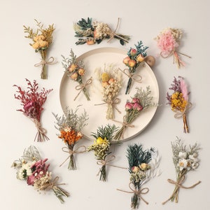 Assorted mini dried flower bouquets arranged on a plate