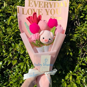Handmade crochet flower plush bouquet with pink flowers and small bunny plush in wrap