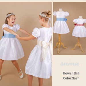 White shantung flower girl dress with puff sleeves, blue sash and large bow