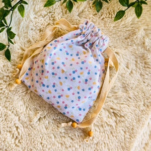 Reusable nursing pad pouch with blue patterned washable pads, drawstring closure