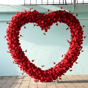 Heart-shaped flower stand with red flowers