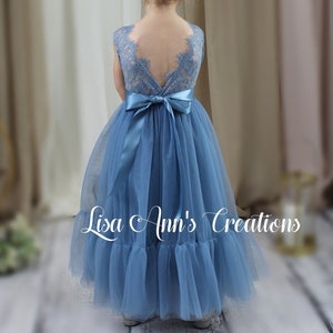 Dusty blue sleeveless flower girl dress with bow back and tulle skirt