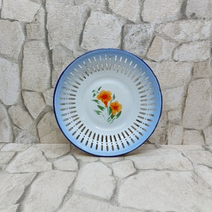 Round blue enamel colander with floral center