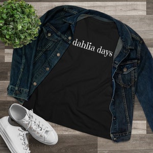 Women's black premium tee with 'dahlia days' script logo on the chest